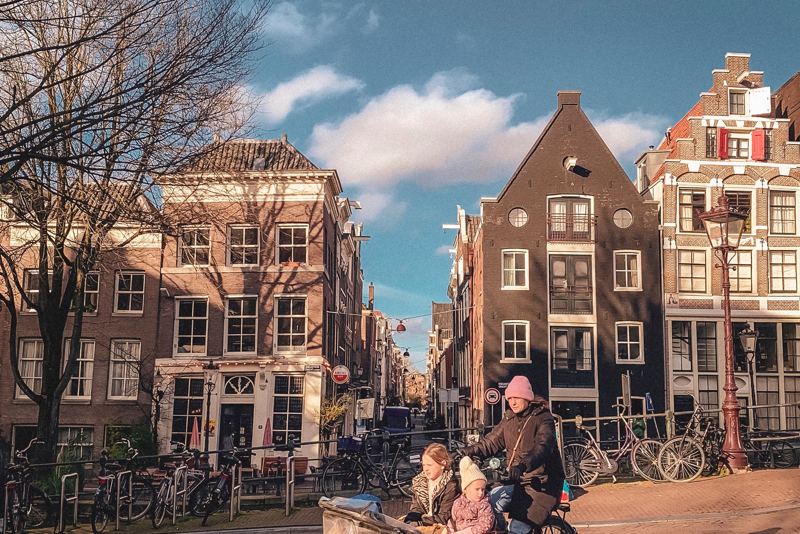 A family cycling down the street